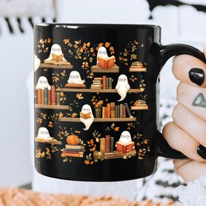 Bookworm girl holding her Halloween mug gift with ghosts reading books pattern.