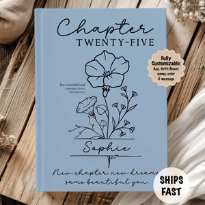 May include: A light blue book with the text "Chapter Twenty-Five" and a floral illustration. The name "Sophie" is below the illustration. The text "New chapter, new dreams, same beautiful you" is at the bottom.