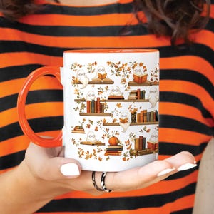 Girls dressed in a Halloween style striped shirt, holding her cute ghosts reading books pattern.