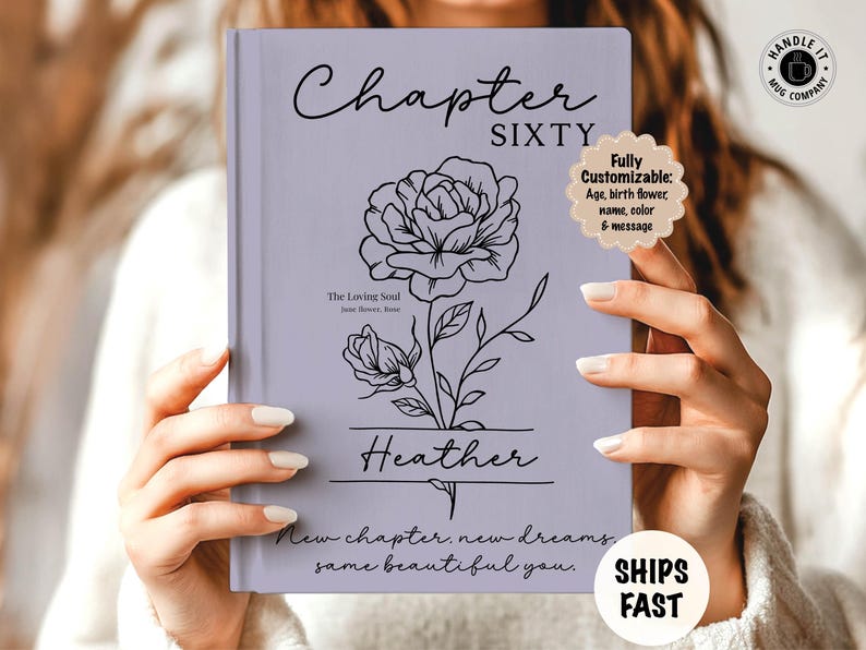 May include: A lavender-colored book with the words "Chapter Sixty" and "Heather" in elegant script. A floral line drawing adorns the cover, with the text "New chapter, new dreams, same beautiful you."