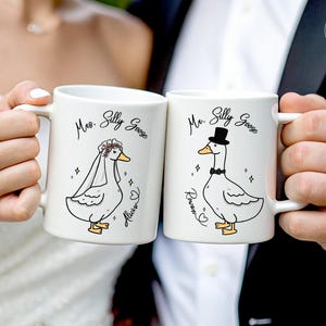 A Bride and Groom holding their Mr and Mrs Silly Goose mugs. Great wedding gift for a friend, son or daughter-in-law. Perfect for bridal showers, engagement parties or a wedding keepsake gift. It comes in 11oz, 15oz and 20oz variants and allows for personalization.