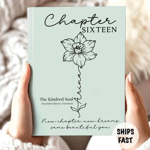 May include: A light sage green book cover featuring the text Chapter SIXTEEN at the top. A black line drawing of a narcissus flower is centered with the name Arina written vertically down the stem. Text includes The Kindred Soul, December flower, Narcissus, and New chapter, new dreams, same beautiful you.