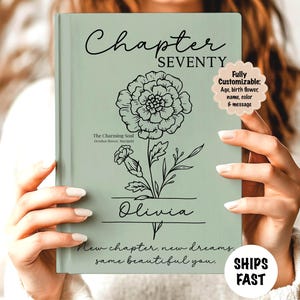 May include: A sage green book cover with the words "Chapter Seventy" and a floral illustration. The name "Olivia" is below the flower. Text includes "The Charming Soul" and "New chapter, new dreams, same beautiful you." A sticker says "Fully Customizable".