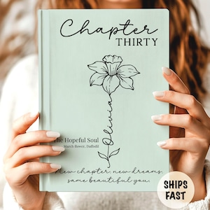 May include: A light green book cover with the words "Chapter Thirty" in black script. A black floral illustration with the name "Olivia" is featured. The text "New chapter, new dreams, same beautiful you" is at the bottom.