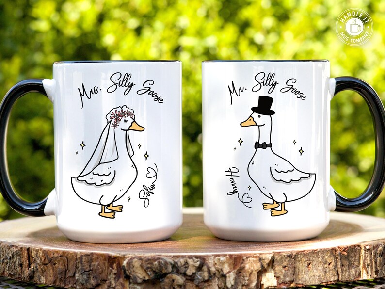 His and hers wedding, engagement or bridal shower mug gift set. Both mugs have a beautiful illustration of Mr Silly Goose (for him), and Mrs Silly Goose (for her). The image shows this masterpiece of a wedding keepsake sitting on a tree stump with lush greenery as the backdrop. Great gift for a friend, son, daughter or daughter in law on his/her wedding. It comes in 11oz, 15oz and 20oz variants and allows for personalization.