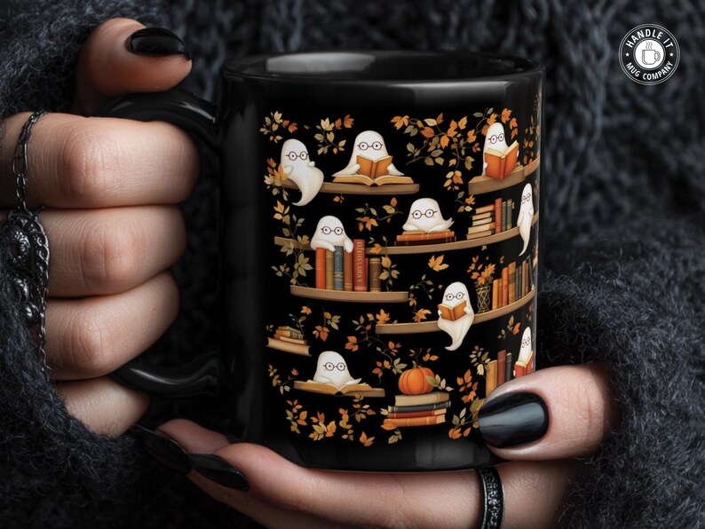 Gothic girl holding her Halloween mug gift with a repeating ghosts reading books pattern.