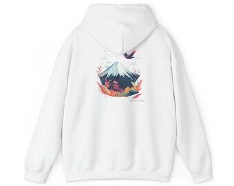 May include: A white hooded sweatshirt featuring a graphic on the back. The design depicts a snow-capped mountain, a pagoda, and foliage in shades of red, orange, and blue. A bird is flying above the mountain, and the text reads Flying Crane Factory.