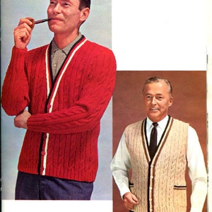 May include: Two men wearing sweaters. The man on the left is wearing a red cable knit sweater with a white stripe down the front. The man on the right is wearing a beige cable knit waistcoat over a white shirt with a dark tie.