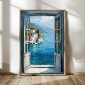 May include: An open window painting with a view of a coastal town. The artwork features a vibrant blue sea, white buildings with red roofs, and green mountains in the background. The window frame is painted in shades of blue and the artwork is in a wooden frame.