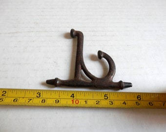 one (1)  antique cast iron hook off a folding coat rack vintage