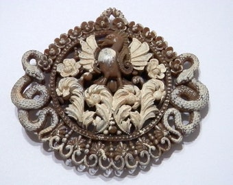 jewelry piece with snakes, phoenix, and floral on it bakelite? buckle? vintage