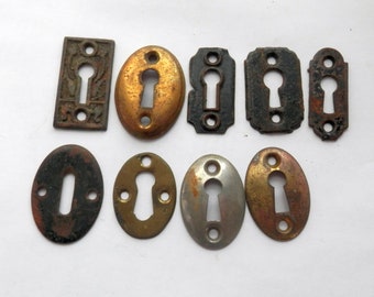 antique cast iron and stamped steel architectural key hole escutcheons