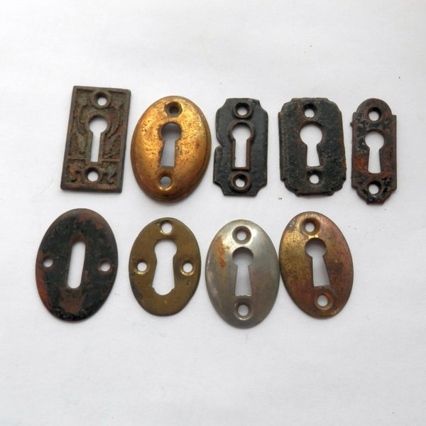antique cast iron and stamped steel architectural key hole escutcheons