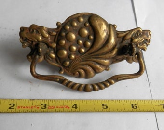 One (1) antique stamped brass drawer pull 3 inch centers with 2 lions on it vintage