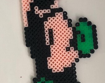 May include: A pixel art character made of black, green, and pink beads. The character is a boxer wearing green shorts and gloves, and is in a punching pose.