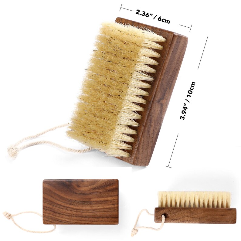 May include: A wooden nail brush with natural bristles. The brush measures 3.94 inches (10 cm) long and 2.36 inches (6 cm) wide. It has a dark brown wooden handle and a loop for hanging.
