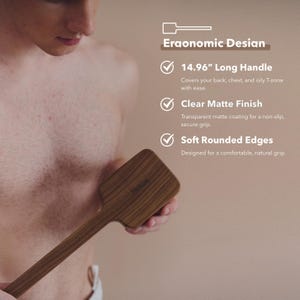 May include: A wooden back scrubber with a long handle, approximately 15 inches, and a clear matte finish. The scrubber has soft, rounded edges for a comfortable grip. The text on the image says "Eraonomic Desian".