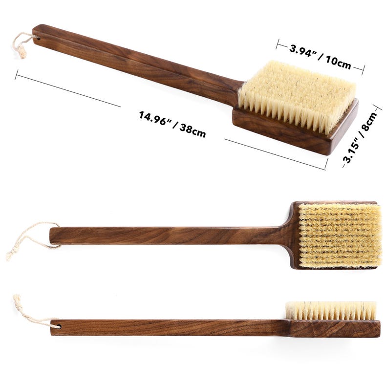 May include: A wooden back brush with a long handle and natural bristles. The brush head is rectangular, measuring 3.94 inches wide and 3.15 inches long. The handle is 14.96 inches long, with a loop for hanging. The wood is a dark brown color.