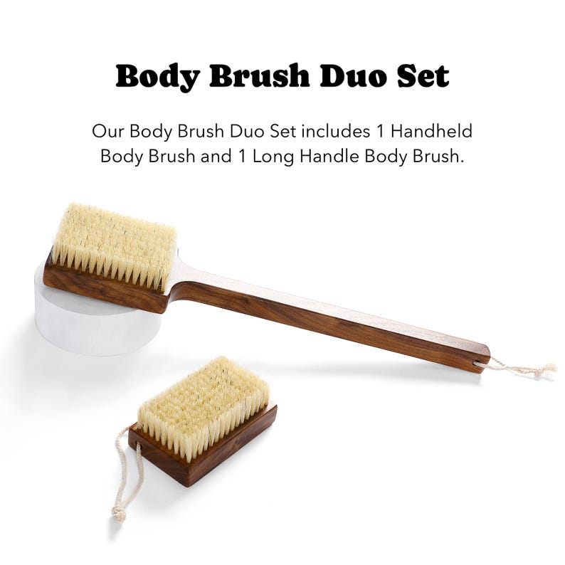 May include: A Body Brush Duo Set featuring a handheld body brush and a long-handled body brush. Both brushes have a wooden base and light-colored bristles. The long-handled brush has a white cord for hanging.