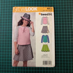 May include: A New Look sewing pattern for tweens, showing a pink and grey top with a star, and a patterned skirt. The pattern offers different design options and is sized for UK 8-18 and Euro 36-46.