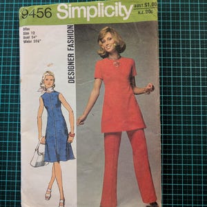 May include: Simplicity sewing pattern number 9456 for a dress and trousers. The pattern is for a size 12, with a bust measurement of 34 inches and a waist measurement of 25 1/2 inches. The pattern shows a model wearing a red dress and trousers, and another model wearing a blue dress.