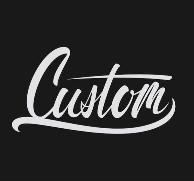 Peut inclure: Le mot Custom est &eacute;crit dans une police cursive stylis&eacute;e blanche sur un fond noir uni. Le lettrage pr&eacute;sente un soulignement prononc&eacute; et balayant qui s'&eacute;tend de la base de la lettre C jusqu'&agrave; la fin du mot.