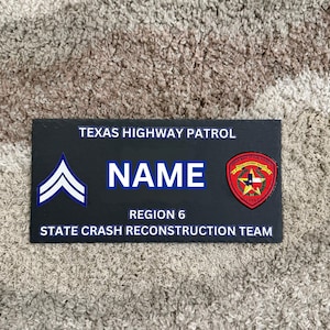 May include: A rectangular black patch featuring the white text TEXAS HIGHWAY PATROL, a blue chevron rank insignia, the word NAME in large blue letters, a circular Texas Department of Public Safety emblem, REGION 6, and STATE CRASH RECONSTRUCTION TEAM.