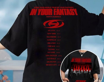 May include: Black t-shirt featuring the text "IN YOUR FANTASY" in red, with a stylized logo and a list of North American tour dates for ATEEZ 2025. The shirt has short sleeves.
