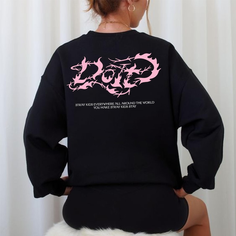 May include: Black crewneck sweatshirt with a pink graphic design on the back. The design features the word "Love" in a stylized font, with the text "Stray Kids Everywhere All Around The World You Make Stray Kids Stay" below.