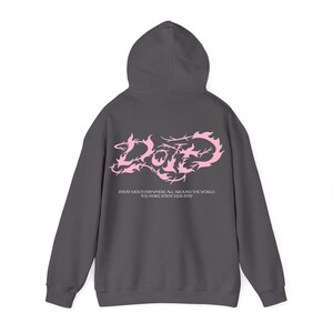 May include: A dark gray hoodie with a hood and long sleeves. The back of the hoodie features the word "Date" in pink, stylized with a decorative font. Below the word is the text "Stray Kids everywhere all around the world, you make Stray Kids stay."
