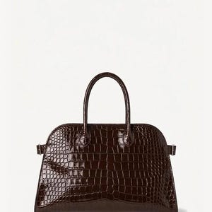 May include: A dark brown, structured handbag with a crocodile-skin texture. The bag has a curved top, a short handle, and a rectangular base. The hardware is minimal, with small metal accents on the sides.