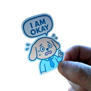 I Am Okay-vinylsticker verkrijgbaar in matte, holografische en glanzende grappige stickers: sticker waterfles, laptop, dagboek