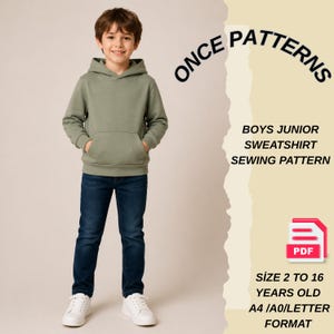 May include: A young person wearing a sage green hoodie and dark blue jeans, with white sneakers. The image includes text that reads "ONCE PATTERNS" and "BOYS JUNIOR SWEATSHIRT SEWING PATTERN". The PDF pattern is for sizes 2 to 16 years old.