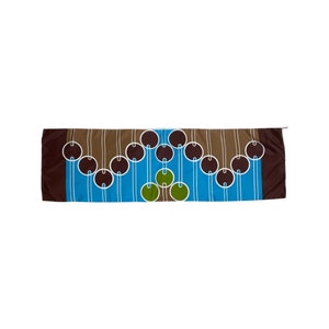 May include: A brown, blue, and green patterned scarf with a geometric design of circles and lines.