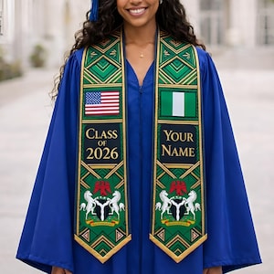 May include: A blue graduation gown with a matching cap. The gown features a sash with the American flag and the Nigerian flag. The sash also has the text "CLASS OF 2026" and "YOUR NAME". The sash has a green and gold design.