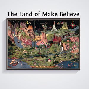 May include: A framed, colourful map titled "The Land of Make Believe." The map depicts a whimsical landscape with castles, rivers, and fantastical elements. The artwork is framed in a black border and mounted on a white wall.