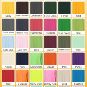 May include: A color chart featuring a variety of t-shirt colors, including Antique Orange, Azalea, and Forest Green. The text "KID TSHIRT" is displayed at the bottom. The chart includes a wide range of hues, from light to dark.