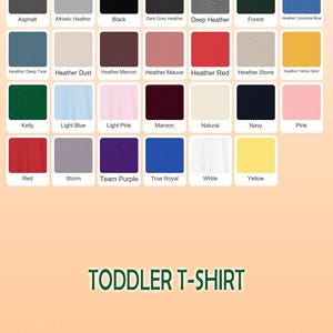 May include: A color chart for toddler t-shirts, featuring a variety of solid colors including black, red, and blue. The chart displays the color names, such as "Asphalt" and "Heather Red", with each color represented by a square.