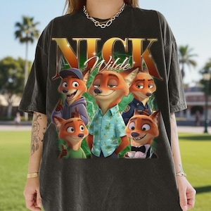 May include: Dark gray t-shirt featuring a graphic of the character Nick Wilde from the animated movie Zootopia. The graphic includes the name "Nick Wilde" in gold lettering and multiple images of the character in various outfits.