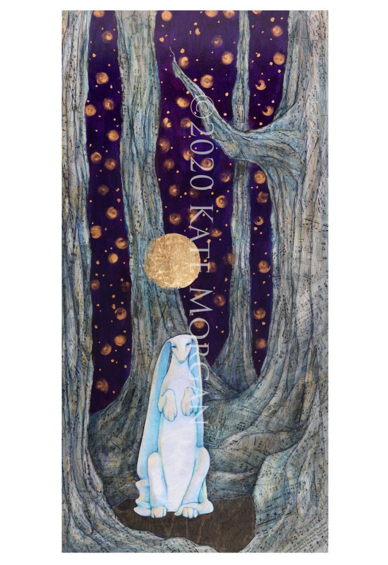 A white hare sits upright among large, textured gray tree trunks. The deep purple night sky is filled with gold stars, crescent moons, and a round golden moon behind the hare. This dreamy, mystical scene captures the essence of Kate Morgan Art.