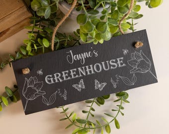 May include: A rectangular black slate sign with a hanging jute rope. The sign features the engraved white text "Jayne's GREENHOUSE" surrounded by line art illustrations of two tulips, two butterflies, small bees, and leafy botanical sprigs.