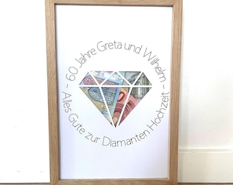 May include: A framed print with a diamond shape made of euro bills. The text around the diamond reads "60 Jahre Greta und Wilhelm - Alles Gute zur Diamanten Hochzeit - "
