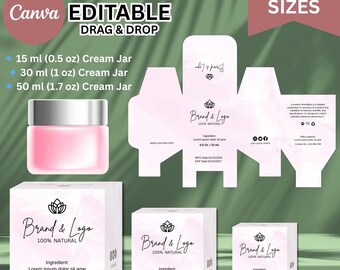 May include: A mockup of a cream box design with the text "Cream Box" and "Editable Drag & Drop". The design includes a pink cream jar and three box sizes: 0.5 oz, 1 oz, and 1.7 oz. The boxes feature a logo and the words "100% Natural".