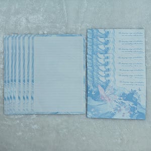 May include: A pack of 10 blue stationery note cards with a butterfly design and the text "The flapping wings of butterflies are resonating with freedom".