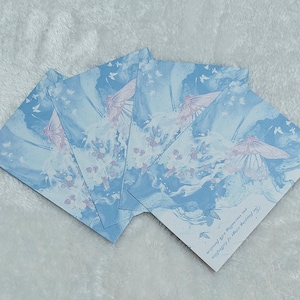 May include: Four blue and white cards with a watercolor design of butterflies and flowers. The text on the card reads "The true colors of happiness are smiles and laughter".
