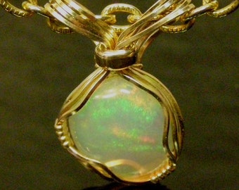 5017 Precious Opal Pendant wire wrapped Ethiopian Welo opal pendant hand made wire wrapped Ethiopian Welo opal pendant from thegemdealer