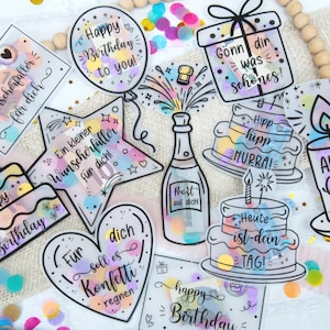 May include: A selection of birthday stickers with diverse designs, including cakes, a champagne bottle, a gift box, and a balloon. The stickers are adorned with colourful confetti and phrases such as "Happy Birthday" and other celebratory messages.