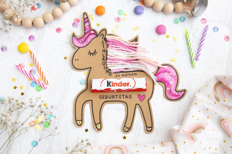 May include: A pink and brown unicorn birthday invitation with a Kinder chocolate bar and the text "Einladung zu meinem Geburtstag".