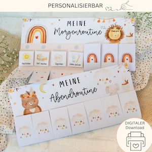 Peut inclure: Deux cartes illustrées avec le texte "MEINE Morgenroutine" et "MEINE Abendroutine". Les cartes présentent des illustrations à l'aquarelle d'un arc-en-ciel, d'un soleil, d'un lion, d'un ours et de nuages. La carte du haut porte le mot "PERSONALISIERBAR".