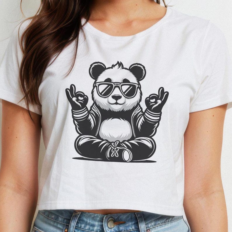 May include: White cropped t-shirt with a black and white illustration of a panda wearing sunglasses and sitting in a yoga pose.